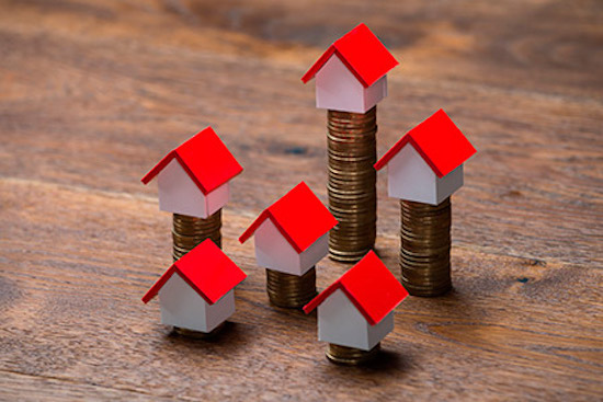 House Models On Stacked Coins