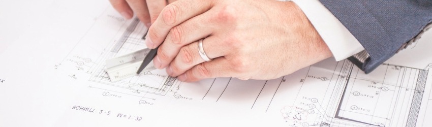 Regime Forfettario 2019: Uomo che disegna su un progetto archittetonico con matita e squadra